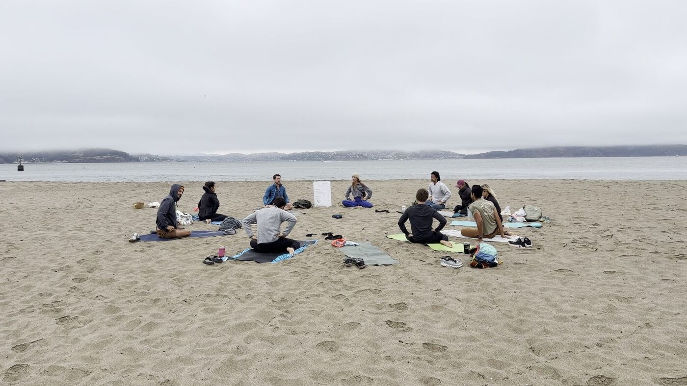 Full Send Fridays group on the beach